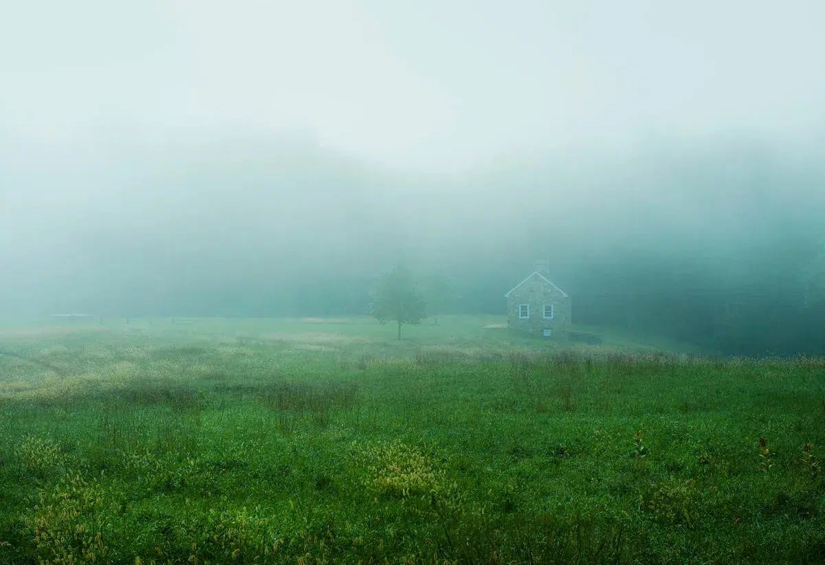 Quaint stone cottage in mist, by John Greim-PurePhoto